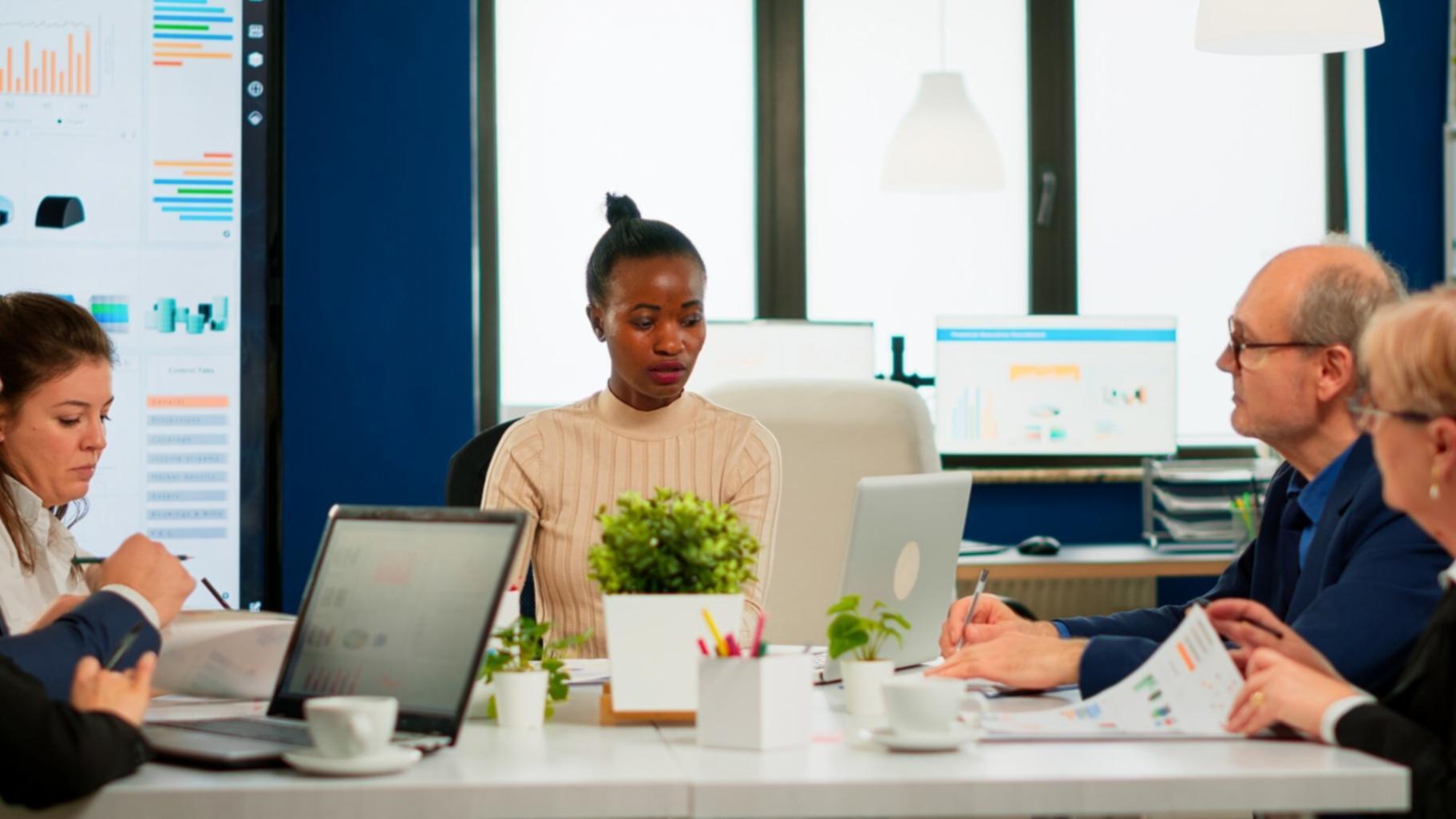 Team reviewing quarterly budget performance metrics on shared screen